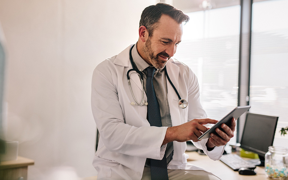 A medical professional looking at Alzheimer’s diagnostic tools on their device