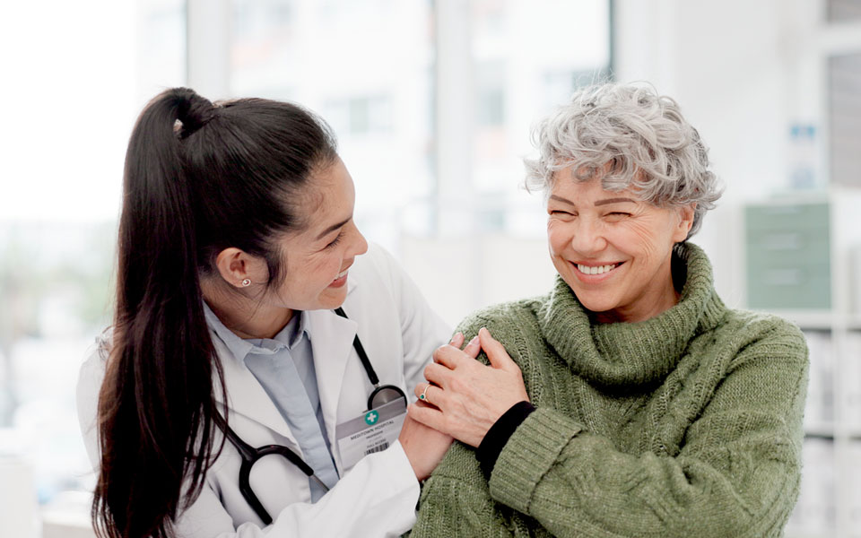 A patient and their doctor smiling at each other
